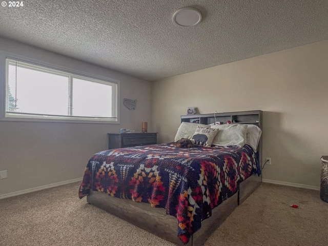 bedroom featuring light colored carpet and a textured ceiling