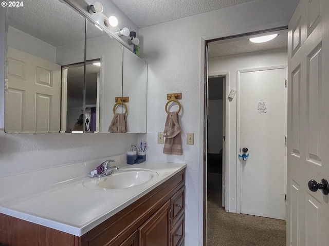 bathroom with vanity and a textured ceiling