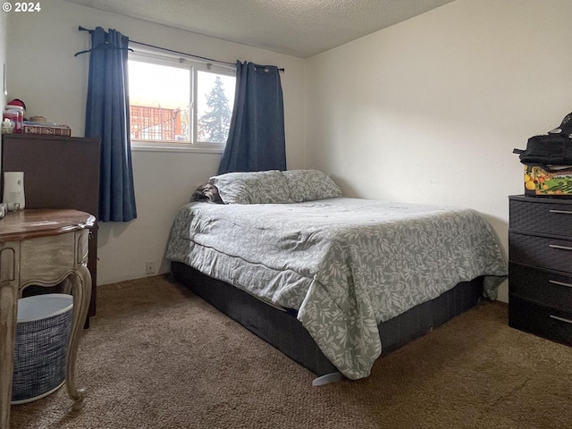 carpeted bedroom featuring a textured ceiling