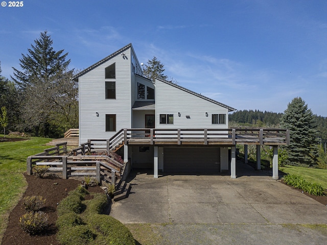 view of front facade featuring a garage, a wooden deck, driveway, and stairway