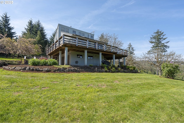 back of house featuring a lawn and a deck