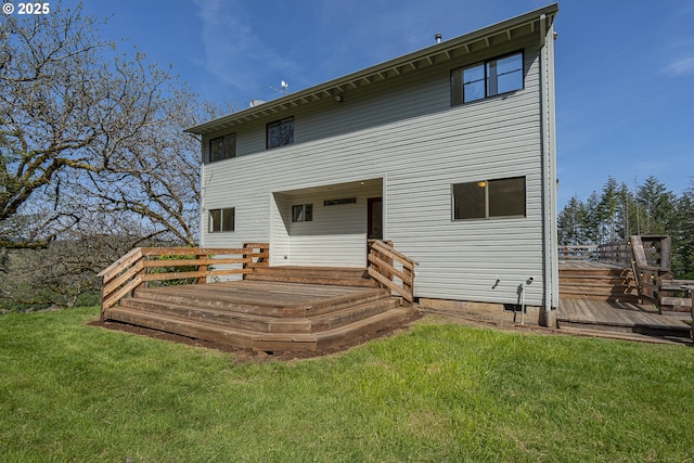 back of house with a yard and a deck