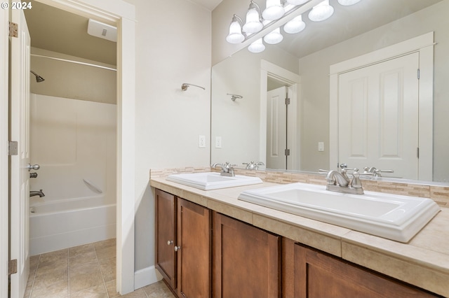 bathroom with tile patterned floors, vanity, and  shower combination