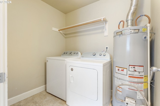 laundry room featuring light tile patterned floors, gas water heater, and independent washer and dryer