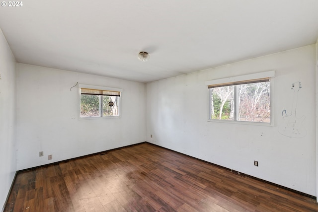 spare room featuring dark wood-type flooring