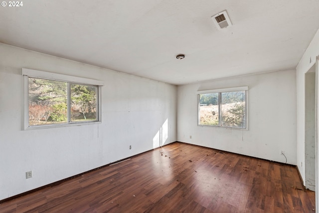 empty room with dark wood-type flooring