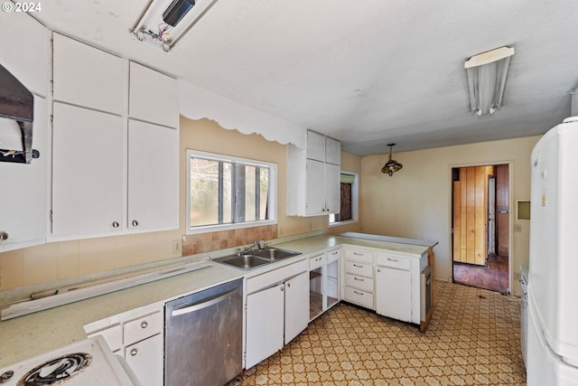 kitchen featuring dishwasher, sink, kitchen peninsula, white fridge, and white cabinets