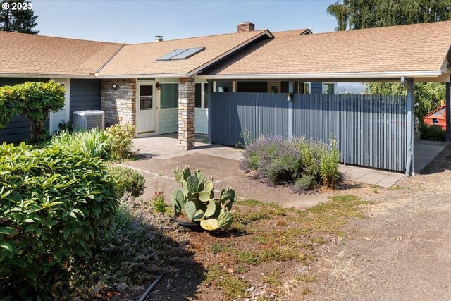 exterior space featuring central air condition unit and solar panels