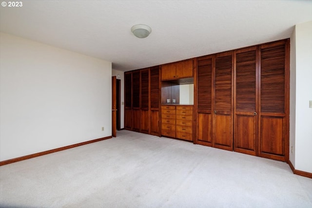 unfurnished bedroom featuring light carpet