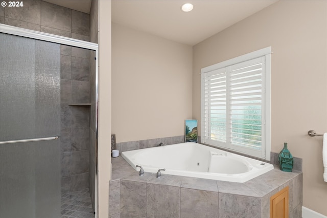 bathroom featuring separate shower and tub