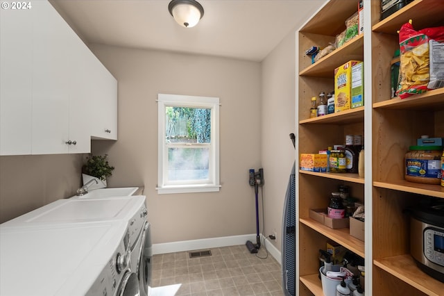 clothes washing area featuring cabinets, sink, and washing machine and dryer