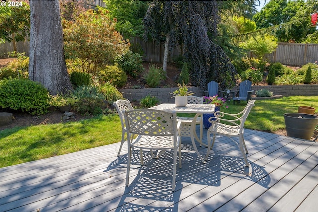 wooden terrace featuring a yard