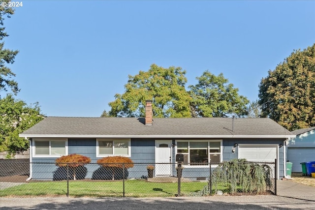 ranch-style home with a garage and a front yard