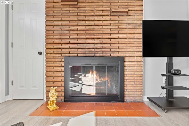 room details featuring hardwood / wood-style flooring and a brick fireplace