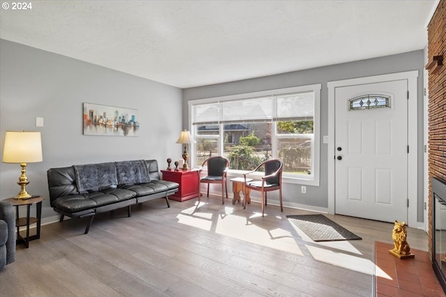 interior space with a textured ceiling, hardwood / wood-style floors, and a fireplace