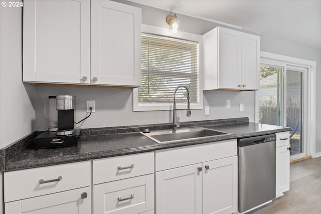 kitchen featuring dishwasher, sink, white cabinets, and light hardwood / wood-style floors