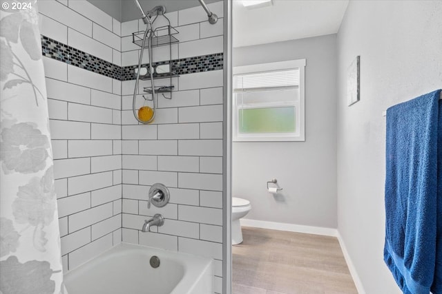 bathroom with toilet, wood-type flooring, and shower / bath combo