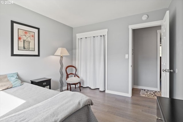 bedroom with dark wood-type flooring