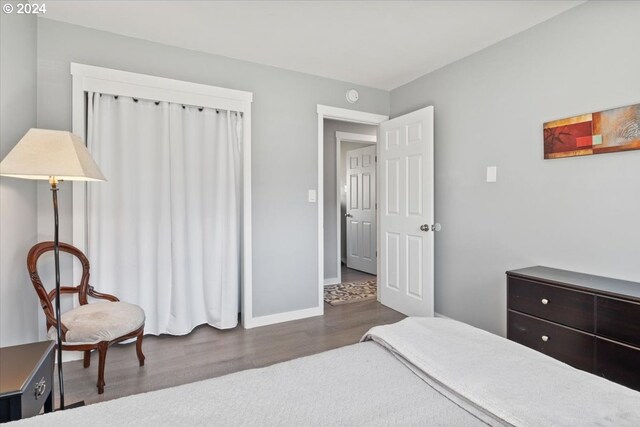 bedroom with dark hardwood / wood-style flooring