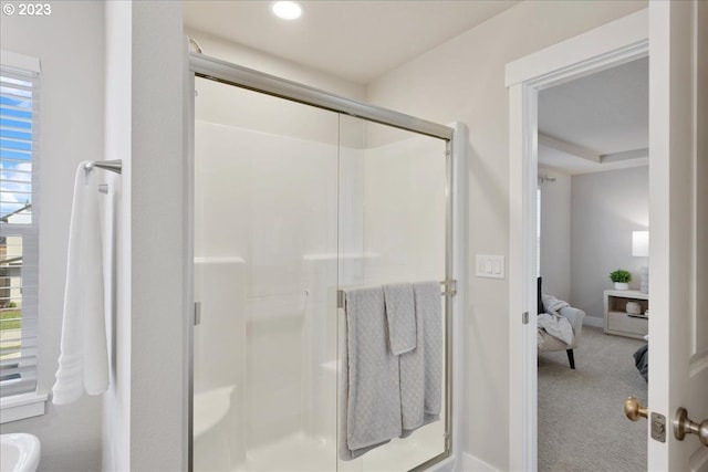 bathroom with a shower with door