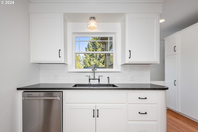 kitchen featuring decorative backsplash, sink, and white cabinets