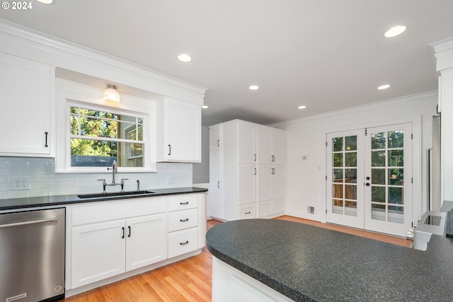 kitchen featuring light wood-type flooring, dishwasher, sink, and white cabinets