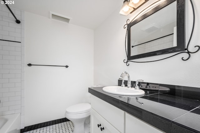 full bathroom with tiled shower / bath combo, vanity, and toilet