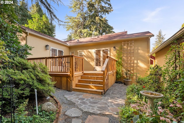 rear view of house with a wooden deck