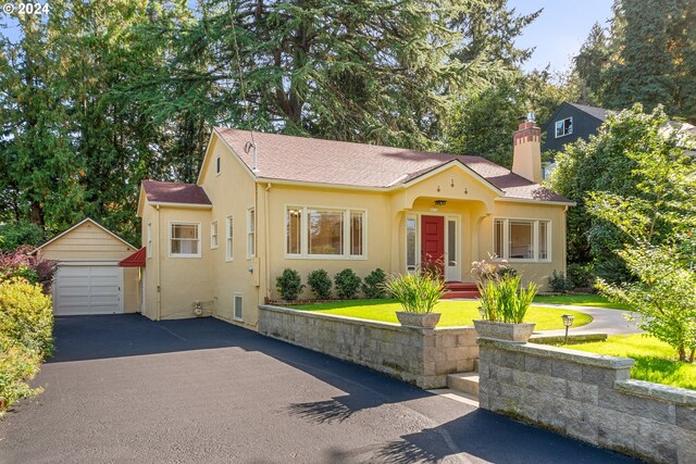 view of front of property with an outbuilding, a garage, and a front yard