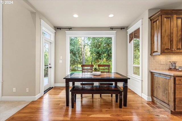 dining room with light wood-type flooring, baseboards, and recessed lighting