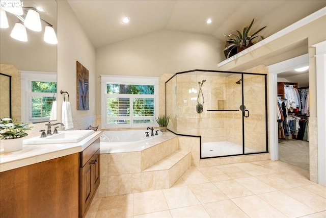 bathroom featuring a stall shower, a healthy amount of sunlight, a garden tub, and a spacious closet