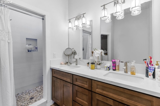 bathroom featuring a notable chandelier, a shower with shower curtain, and double vanity