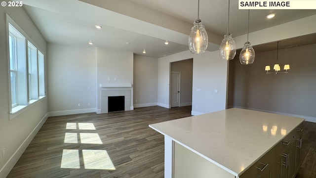 unfurnished living room featuring baseboards, recessed lighting, and a healthy amount of sunlight