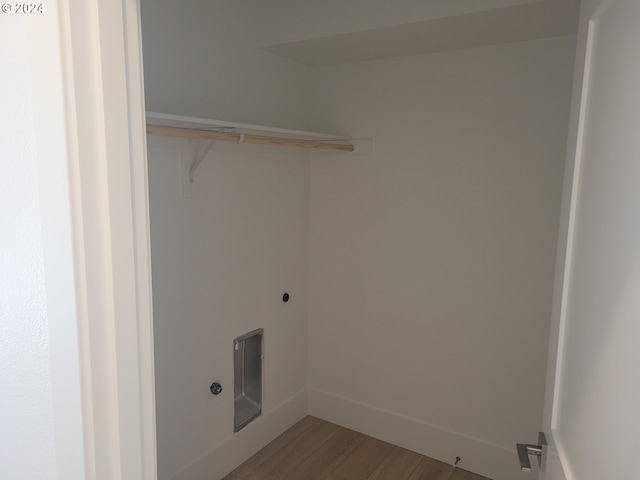 laundry room with hardwood / wood-style flooring and electric dryer hookup