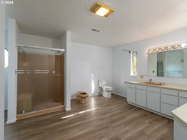 bathroom with vanity, toilet, an enclosed shower, and hardwood / wood-style flooring