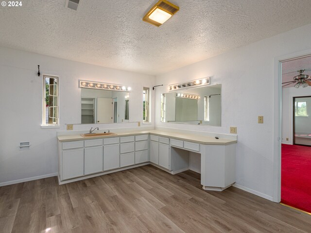 bathroom featuring a textured ceiling, vanity, ceiling fan, and hardwood / wood-style flooring