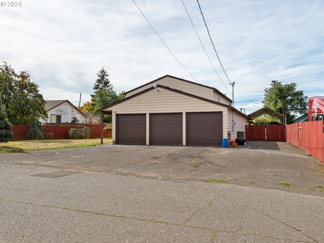 detached garage featuring fence