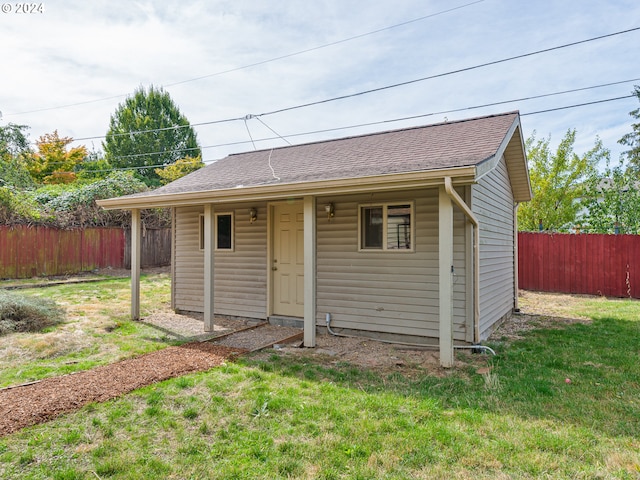 view of outdoor structure featuring a lawn