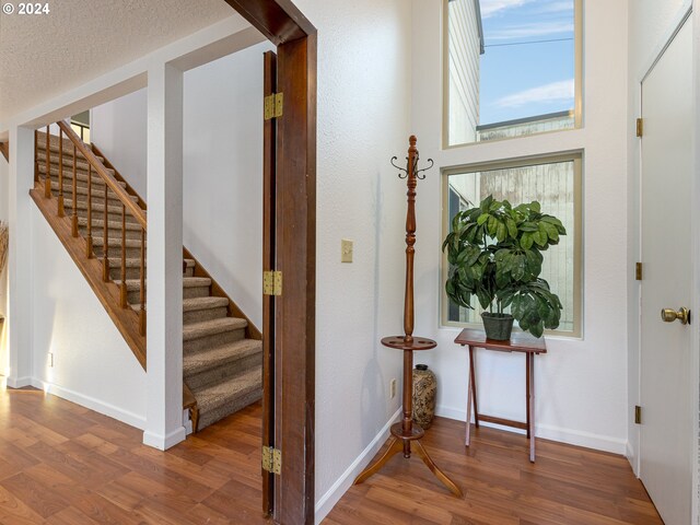 foyer featuring a textured ceiling and hardwood / wood-style flooring