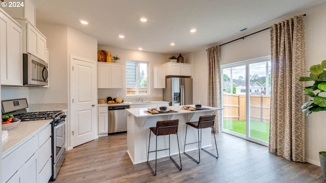 kitchen with sink, white cabinetry, a center island, and stainless steel appliances