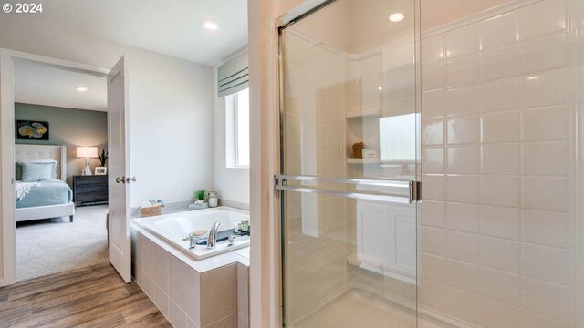 bathroom featuring wood-type flooring and plus walk in shower