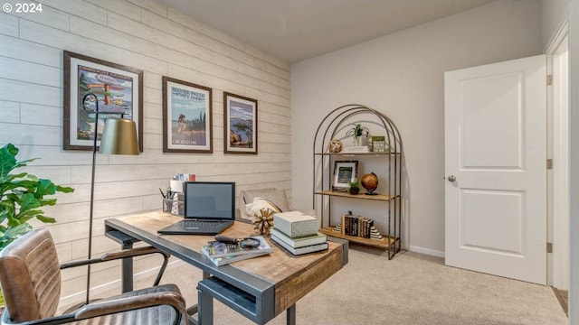 carpeted office featuring wood walls