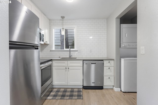 kitchen featuring white cabinets, appliances with stainless steel finishes, light hardwood / wood-style flooring, and sink