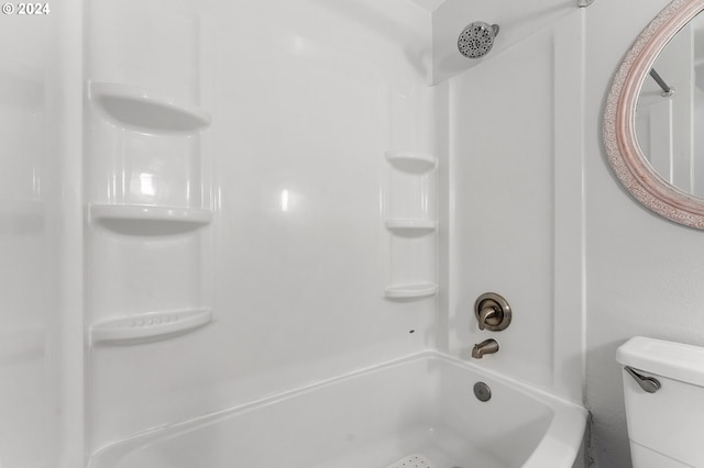 bathroom featuring washtub / shower combination and toilet