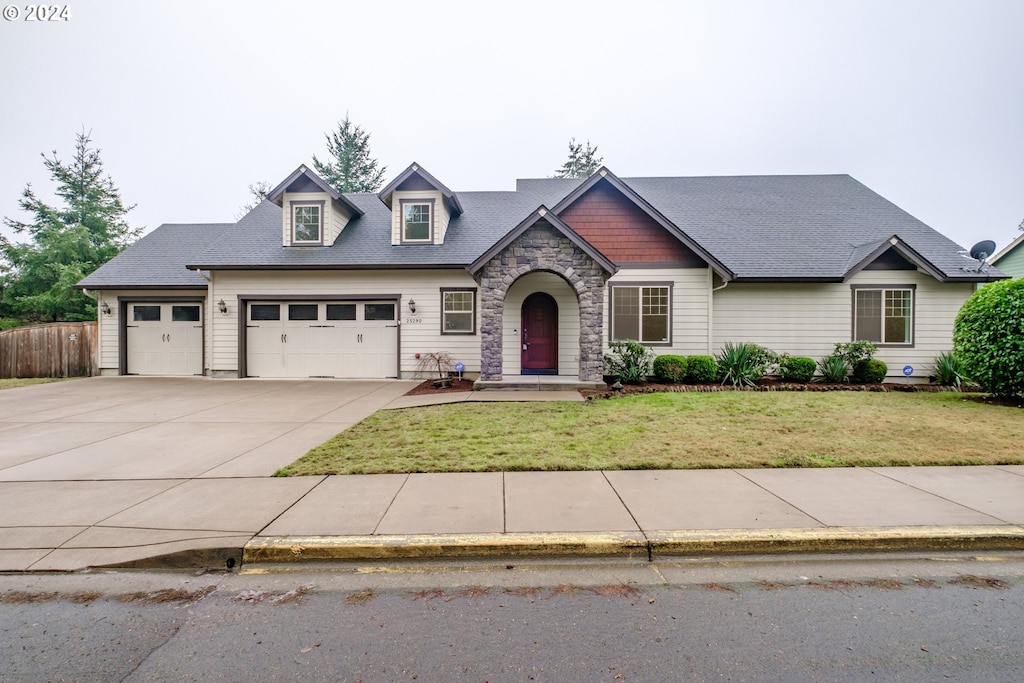 view of front of property featuring a garage and a front yard