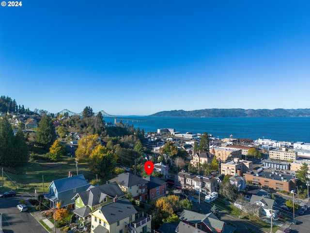 drone / aerial view with a water and mountain view