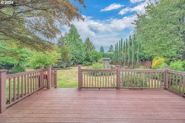 wooden deck featuring a yard