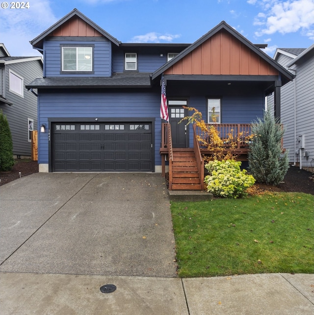 craftsman-style home featuring covered porch, a garage, and a front yard