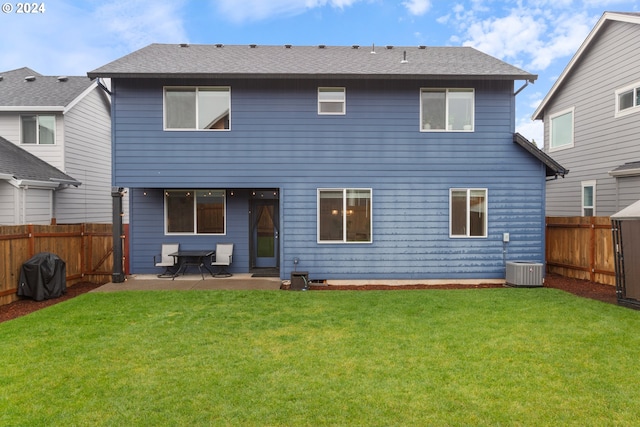 rear view of house with a yard, a patio, and cooling unit