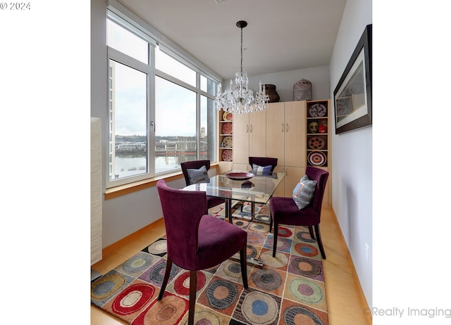 dining room featuring a water view and an inviting chandelier